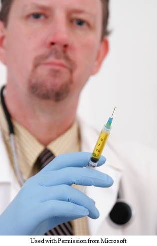 A picture of a doctor holding a needle full of vaccine