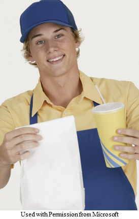 A picture of a food handler holding a takeout bag and cup